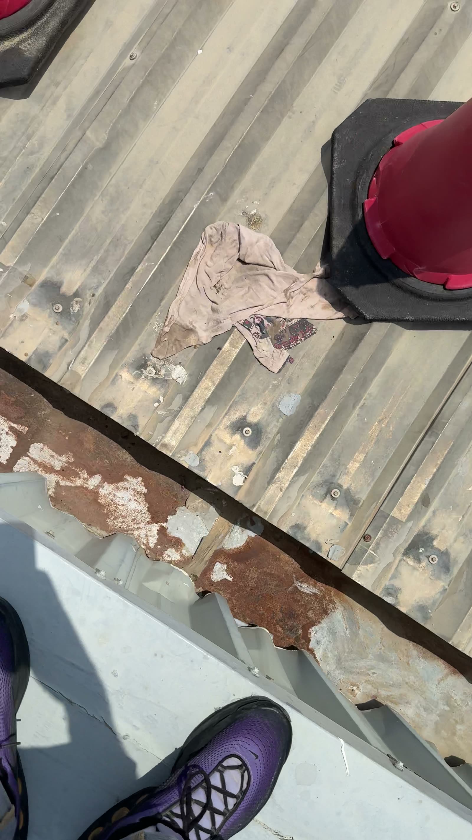 Corroded drainage valley on the warehouse roof before treatment
